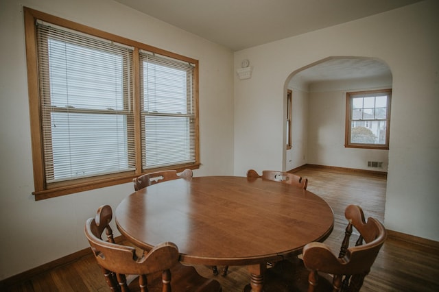 dining room with dark hardwood / wood-style flooring