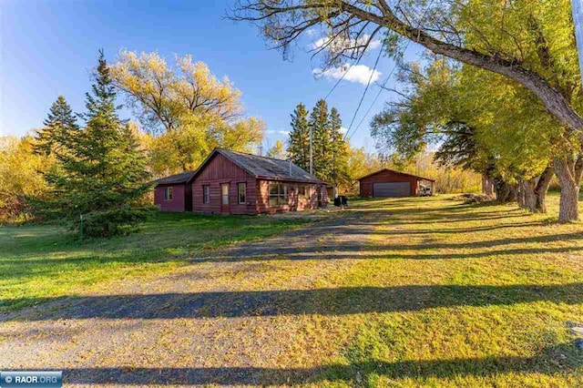 view of yard featuring an outbuilding and a garage