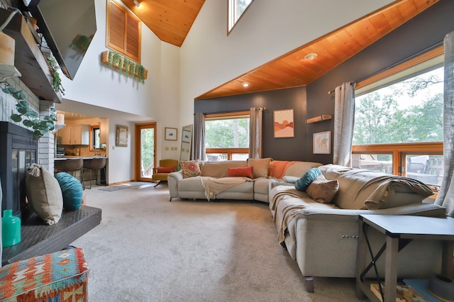 living area featuring carpet flooring, lofted ceiling, and wood ceiling