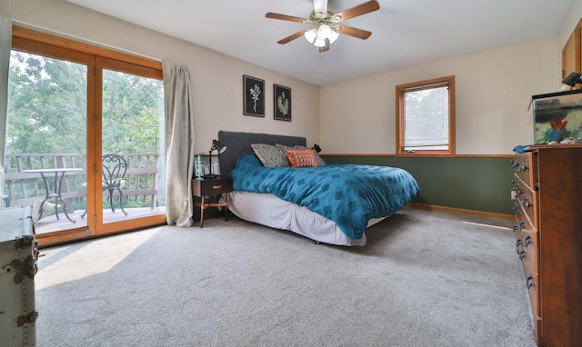 carpeted bedroom featuring access to exterior and a ceiling fan