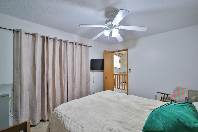 bedroom featuring a textured ceiling, ceiling fan, and carpet flooring