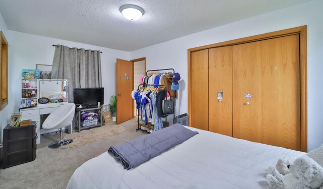 carpeted bedroom featuring a textured ceiling