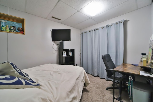 bedroom with visible vents, light carpet, and a drop ceiling