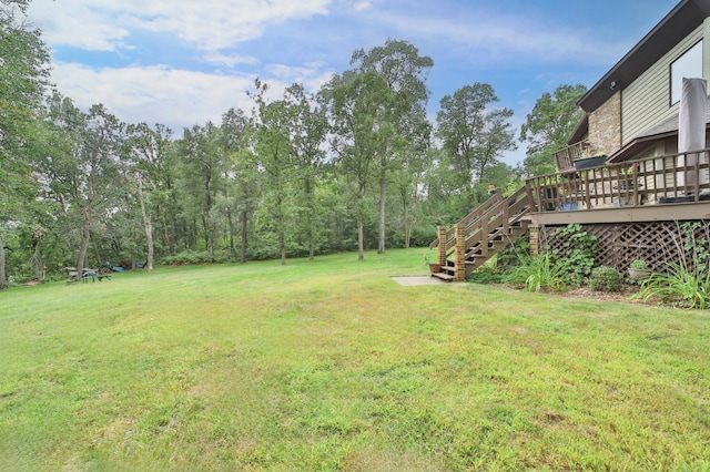 view of yard with a wooden deck and stairs