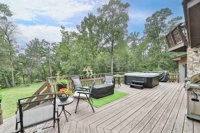 wooden deck with a yard and a hot tub