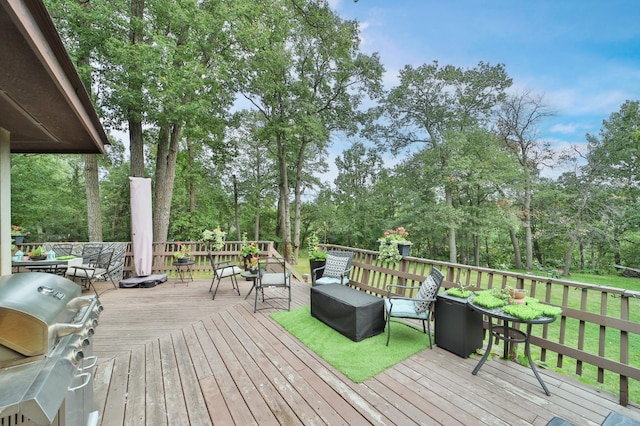 wooden deck featuring area for grilling and outdoor dining area