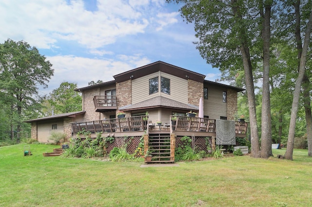 rear view of property with stairway, a yard, and a wooden deck