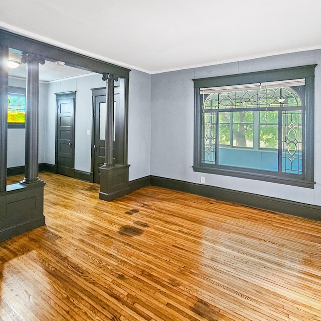 unfurnished room featuring light wood-type flooring and crown molding