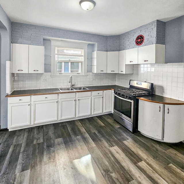 kitchen featuring white cabinets, sink, dark wood-type flooring, and stainless steel range with gas stovetop