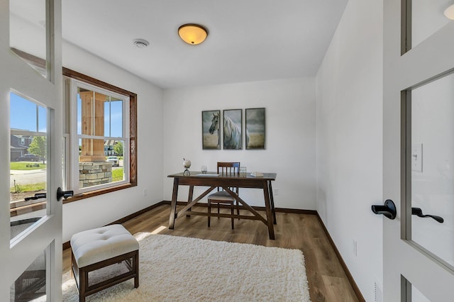 home office with french doors and dark hardwood / wood-style flooring