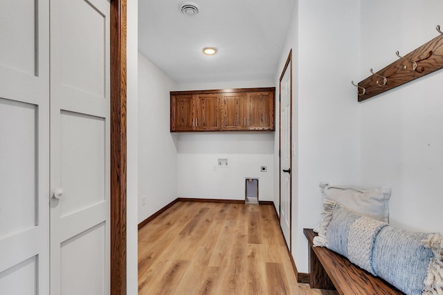 laundry area featuring cabinets, washer hookup, light hardwood / wood-style flooring, and hookup for an electric dryer