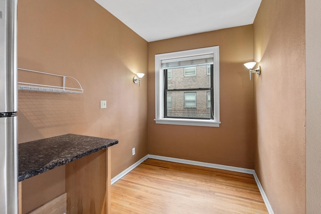 laundry area with light hardwood / wood-style flooring