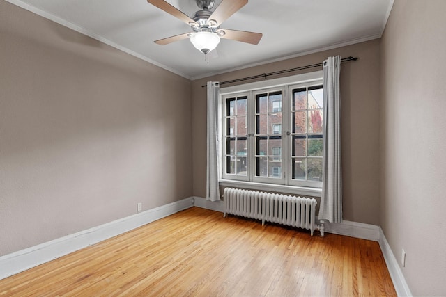 unfurnished room with ceiling fan, ornamental molding, radiator heating unit, and light wood-type flooring