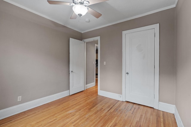 unfurnished bedroom with crown molding, light hardwood / wood-style floors, and ceiling fan