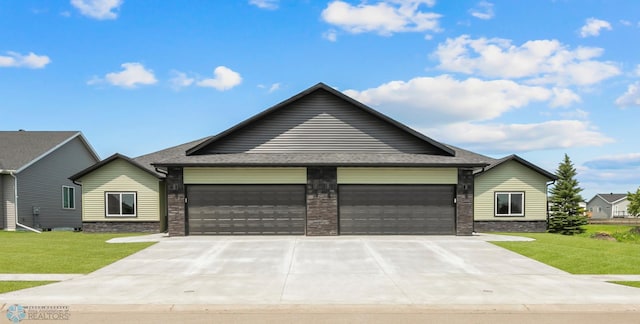 ranch-style house featuring a front yard and a garage