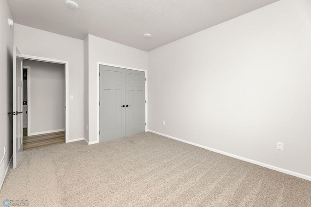 unfurnished bedroom featuring a closet and carpet floors