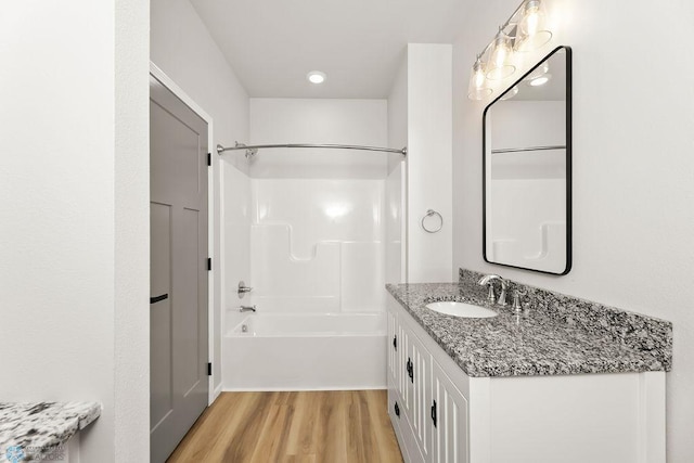 bathroom with vanity, bathtub / shower combination, and hardwood / wood-style floors