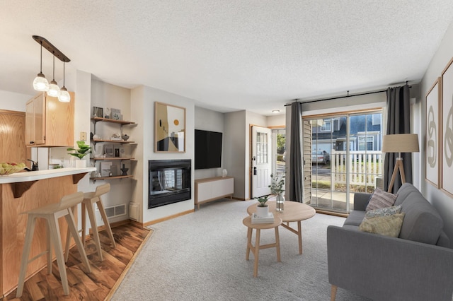 living room with a textured ceiling and light colored carpet