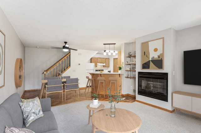 living room featuring ceiling fan and light colored carpet