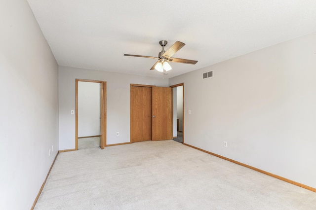 unfurnished bedroom featuring ceiling fan and light carpet