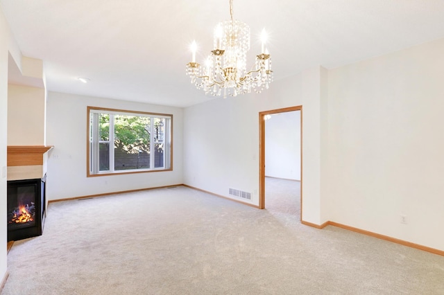 unfurnished living room featuring a notable chandelier and light colored carpet