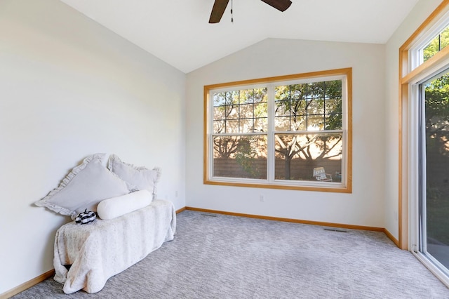 living area with lofted ceiling, carpet flooring, and ceiling fan