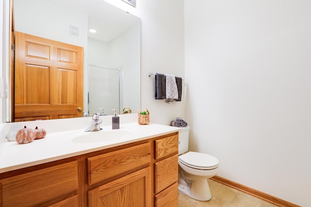 bathroom featuring vanity, toilet, and tile patterned flooring