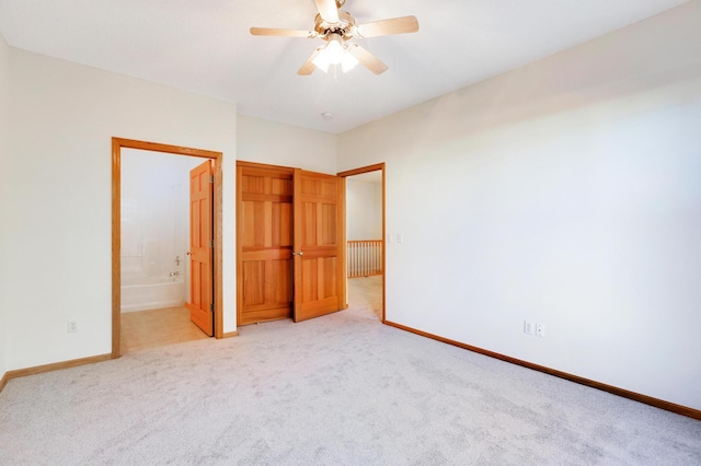 unfurnished bedroom with connected bathroom, light carpet, and ceiling fan