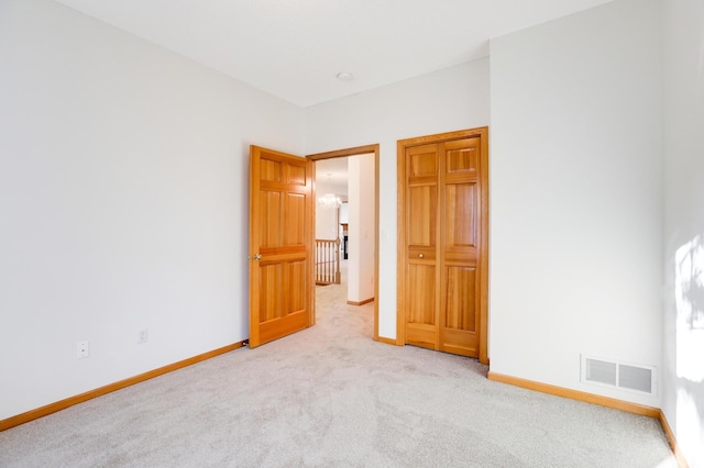 unfurnished bedroom featuring light carpet