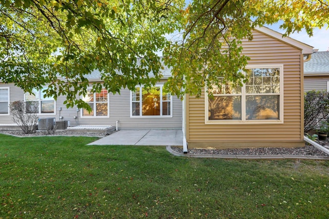 back of house with a patio area, central AC unit, and a lawn