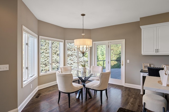 dining space featuring a notable chandelier and dark hardwood / wood-style floors