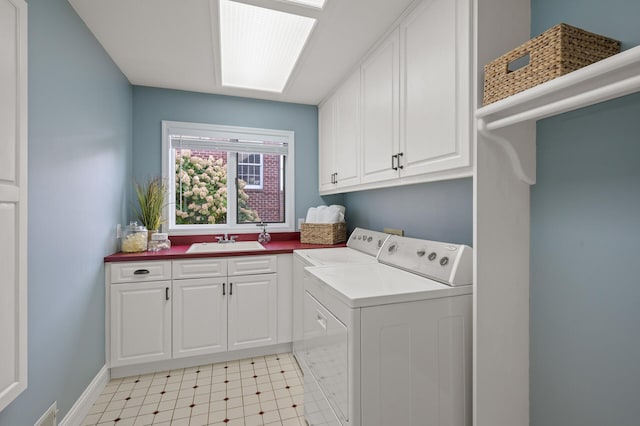 clothes washing area with sink, cabinets, and separate washer and dryer