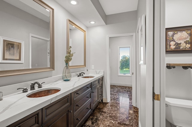 bathroom featuring vanity and toilet