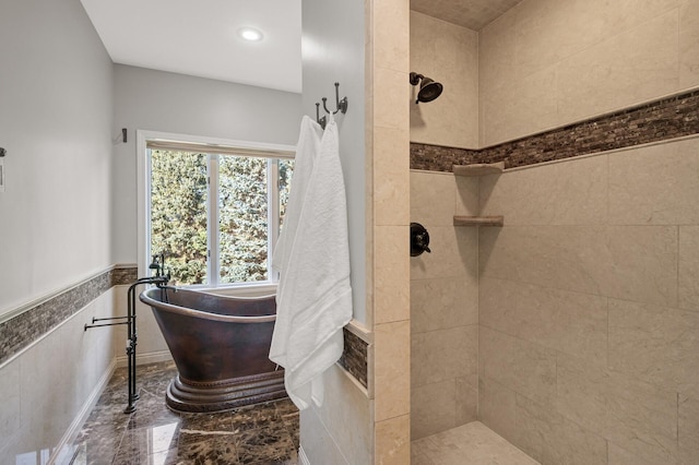 bathroom featuring separate shower and tub