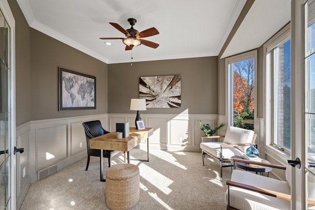 carpeted home office featuring french doors, ornamental molding, plenty of natural light, and ceiling fan