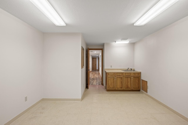 hall with a textured ceiling and sink