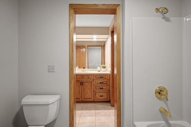 full bathroom with vanity, toilet, tile patterned floors, and washtub / shower combination