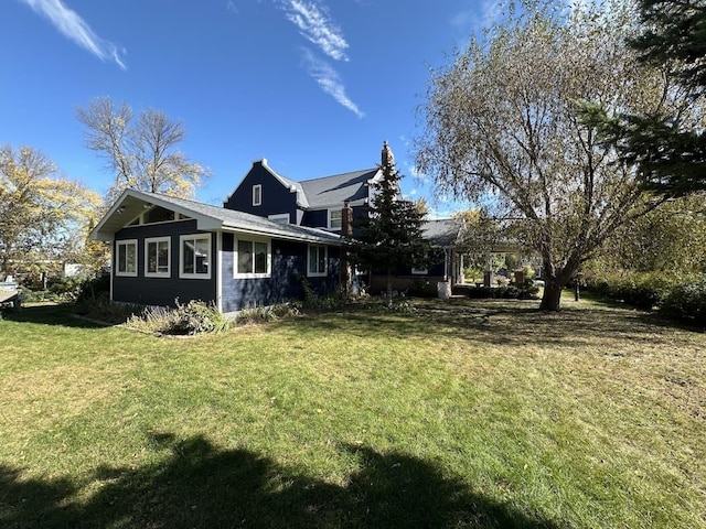 view of side of home featuring a yard