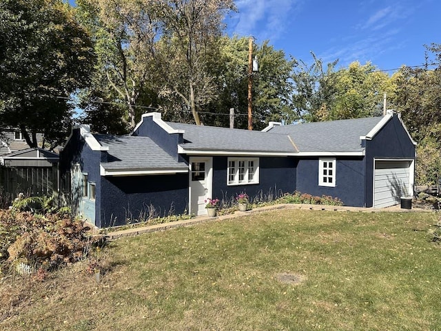 view of front facade with a front lawn and a garage