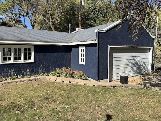 view of property exterior featuring a garage and a yard