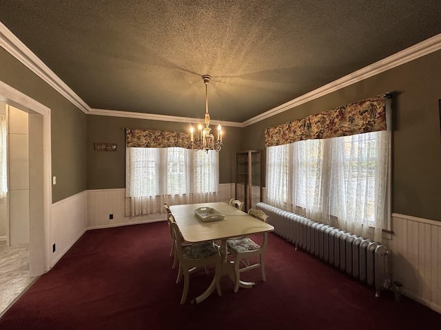 unfurnished dining area featuring dark carpet, a textured ceiling, and ornamental molding