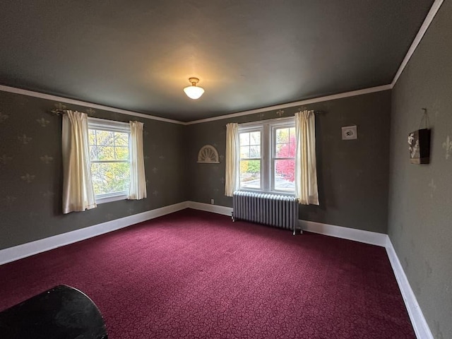 carpeted empty room featuring crown molding and radiator heating unit