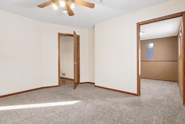 carpeted empty room with ceiling fan, electric panel, and a textured ceiling