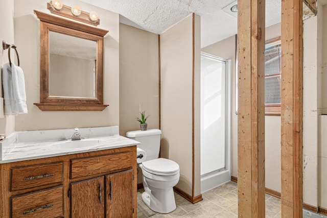 bathroom featuring vanity, toilet, and a textured ceiling