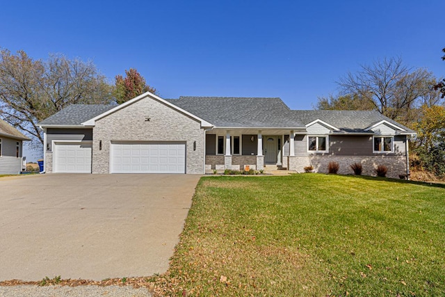 view of front of home featuring a porch, a front lawn, and a garage