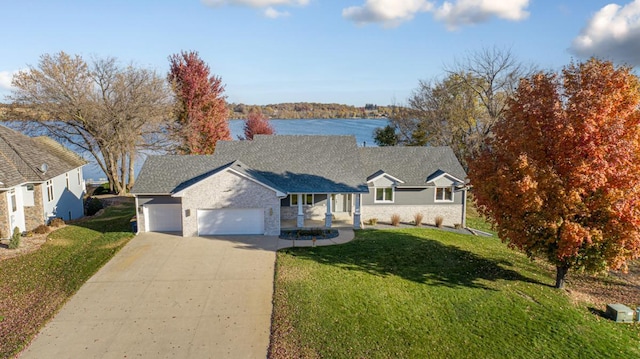 view of front facade featuring a water view, a front yard, and a garage