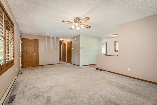 carpeted empty room featuring ceiling fan, a textured ceiling, and baseboard heating