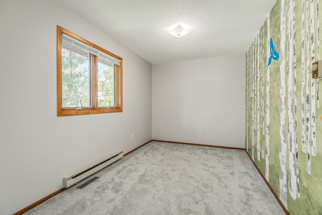 unfurnished room with light colored carpet, a textured ceiling, and baseboard heating