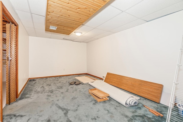 spare room with a drop ceiling and carpet flooring