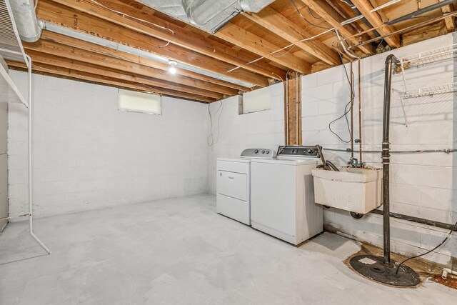 clothes washing area with independent washer and dryer and sink